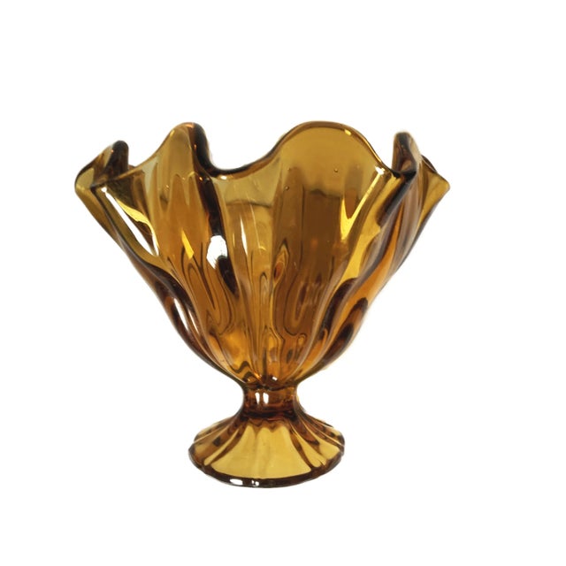 Catching the light with a warm, honeyed glow, this vintage pedestal dish is a testament to Art Glass's artistry. Its base...