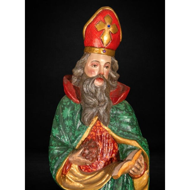 This rare carved wooden sculpture depicts Saint Urban I, Pope and Martyr, portrayed wearing richly decorated pontifical...