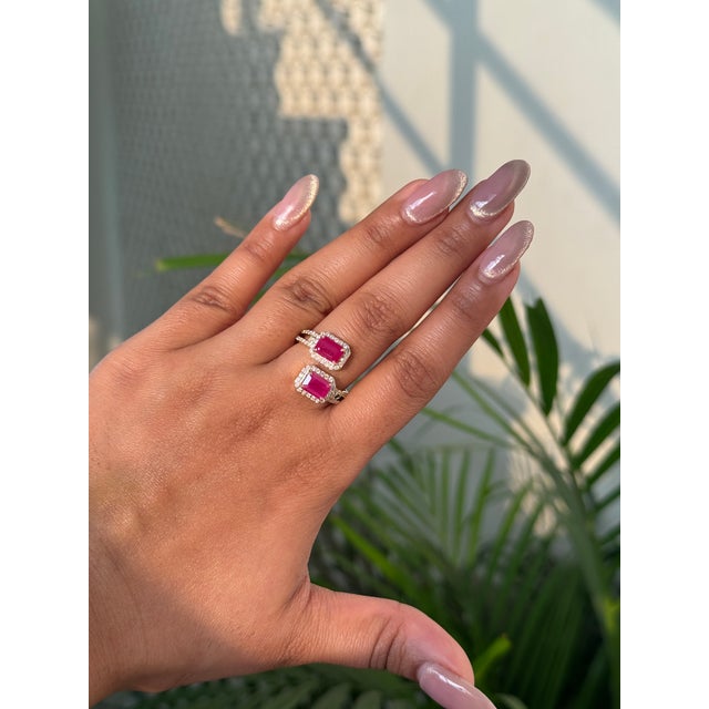 This elegant 3.16 carat emerald-cut ruby and diamond bypass ring is crafted in 14K yellow gold. Each ruby measures...