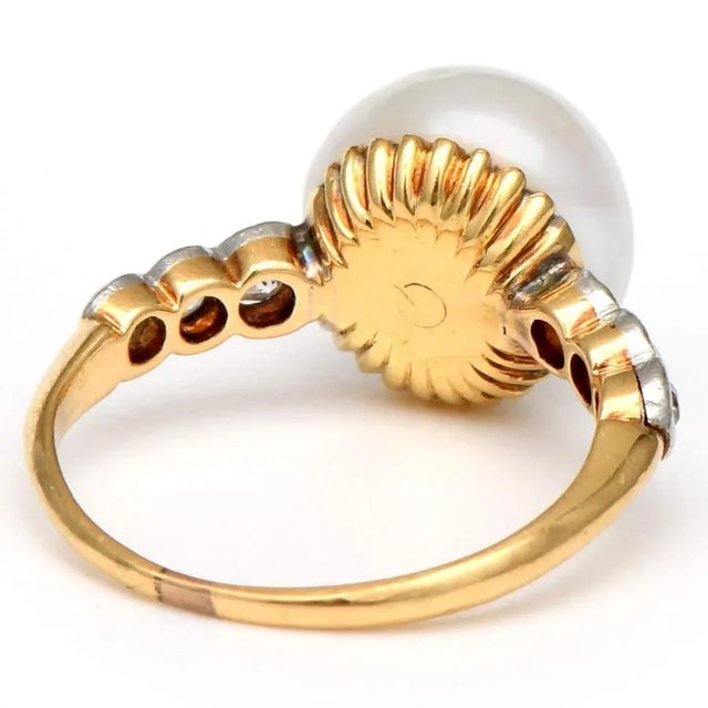 This enchanting freshwater pearl ring features a large, round wild pearl artfully displayed in an accented 18K yellow gold...
