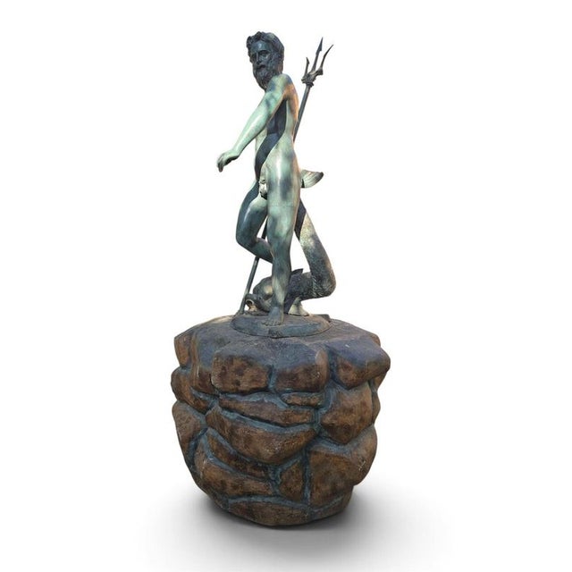 Monumental bronze statue of the god Neptune with patinated finish. Created in the 1970s, this piece is in good condition....