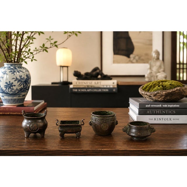 A distinctive set of four antique Chinese bronze miniature censers, each finely cast in a different traditional vessel...
