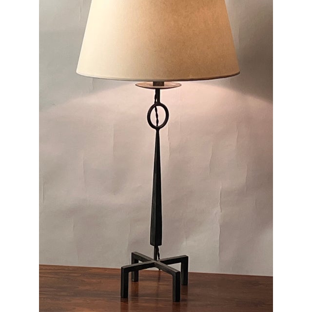 Tall patinated wrought Iron table lamp with European style (no harp or finial) custom parchment shade. Very decorative and...