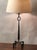 Tall patinated wrought Iron table lamp with European style (no harp or finial) custom parchment shade. Very decorative and...