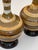 each handcrafted stoneware studio pottery piece of distinct bottle-form shape featuring a long, slender neck that tapers...