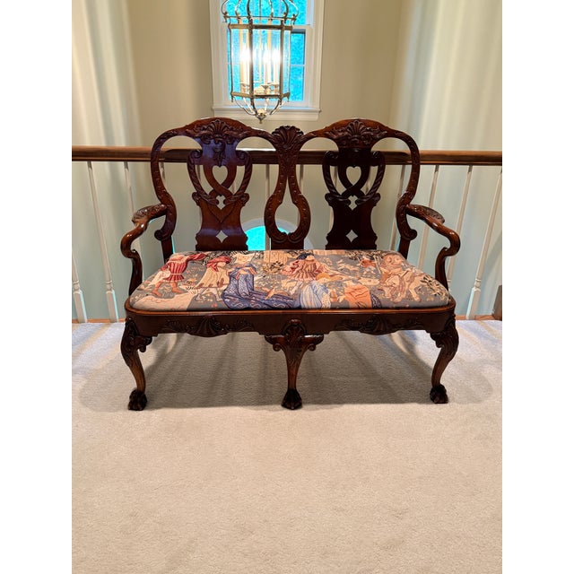 Carved Settee with Needlepoint Seat Believed to be Maitland Smith, this double seat bench has ball and claw feet with...