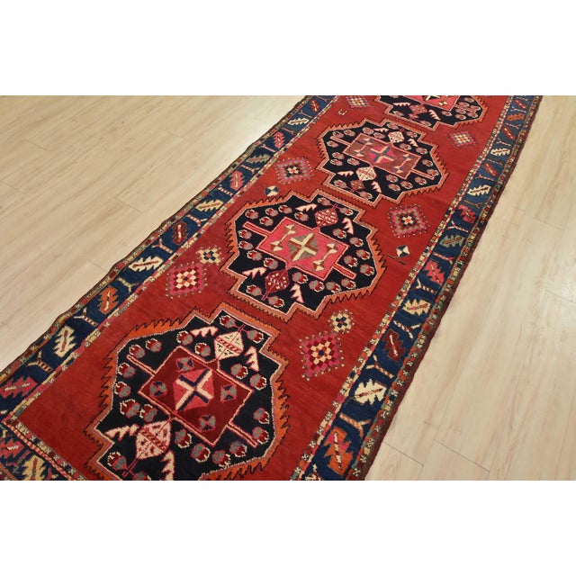 An authentic vintage tribal Caucasian runner hand-knotted with fine wool and natural dyes. This nomadic oriental rug...