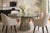 A striking modern dining table inspired by the iconic Warren Platner silhouette, featuring a sculptural wire pedestal base...
