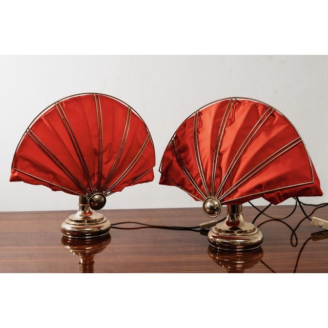 Elegant pair of polished brass table lamps, made in the 1970s and inspired by the refined Hollywood Regency style. The...