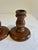 This pair of turned wood candlestick holders features a classic urn-shaped stem on a wide, round base, finished in a warm...
