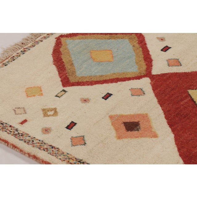 Hand-knotted in wool and originating circa 1950-1959 from Afghanistan, this 3x5 vintage Gabbeh rug joins Rug & Kilim’s...