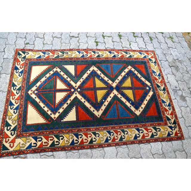 This is a vintage Turkish Oushak rug from the 1960s. The piece was hand-knotted.
