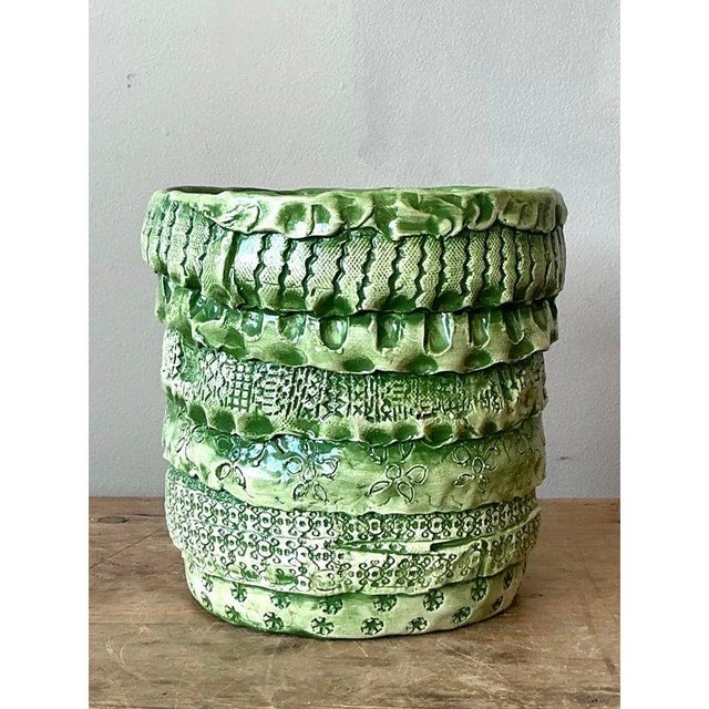 This highly tactile vintage cachepot is a remarkable piece of Studio Pottery, showcasing rich surface manipulation and an...