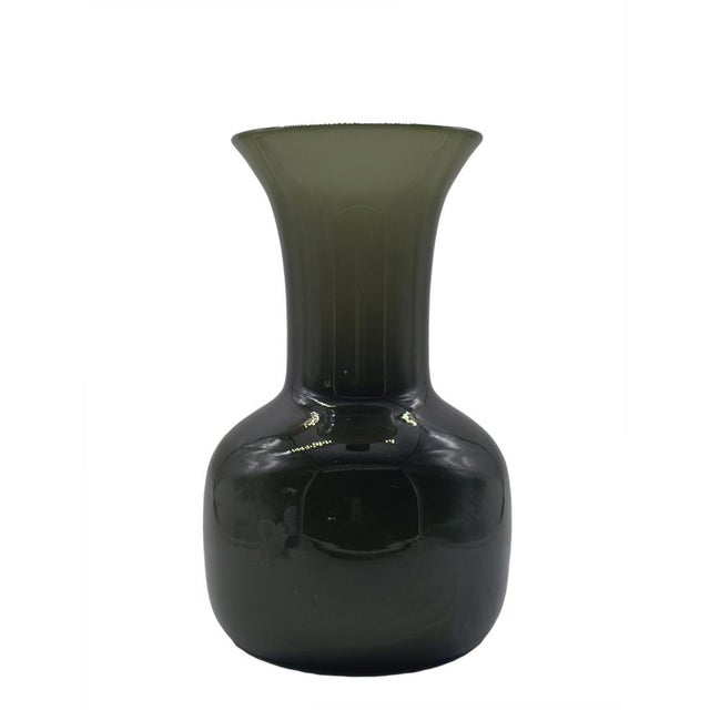 Handmade and hand-blown vase in glossy dark petrol green Murano glass. The vase has a rounded lower body that narrows into...