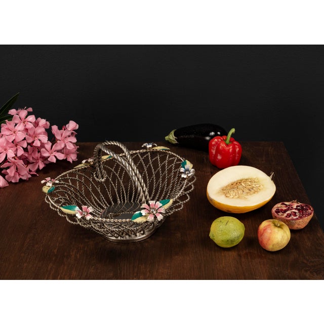 This silver plated Mid Century vintage fruit basket from the 1950s features a delicate yet robust construction made of...