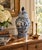 A classic blue and white ginger jar, decorated throughout with delicate bird and flowering branch motifs. The pattern is...