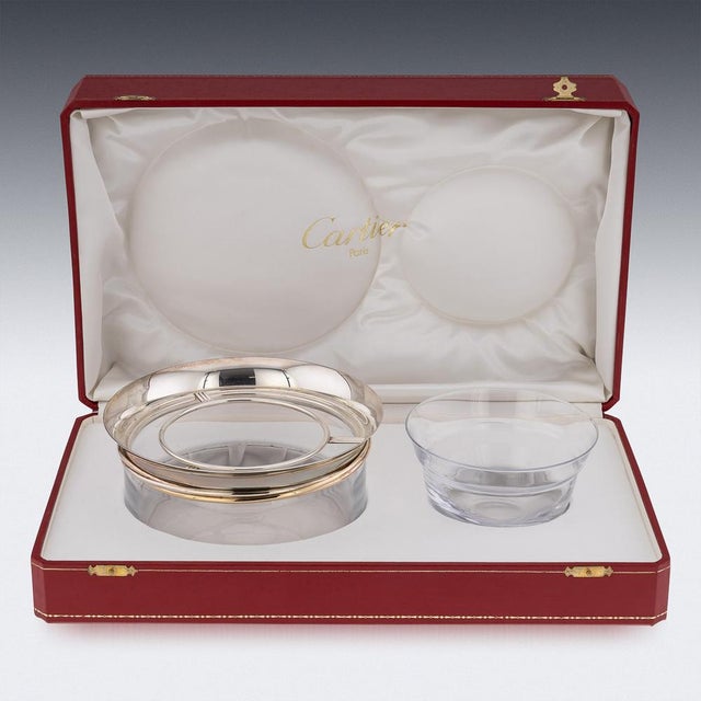 A spectacular Cartier glass caviar bowl and serving spoon, the bowls rim decorated with tri-color gold band and silver...