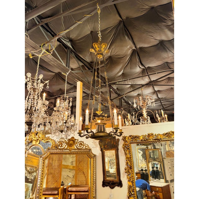 The product is a 19th-century French Empire bronze chandelier. This chandelier embodies the elegance and style of the...