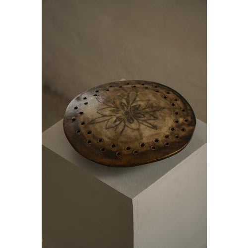 A Danish ceramic wall lamp from the 1970s, in the style of Axella, showcasing a characteristic organic form and earthy...