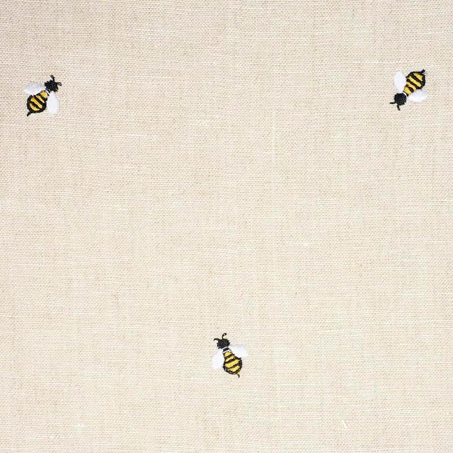 Buzzing with style, this sweet, non-directional design features diminutive honey bees delicately embroidered on a linen...