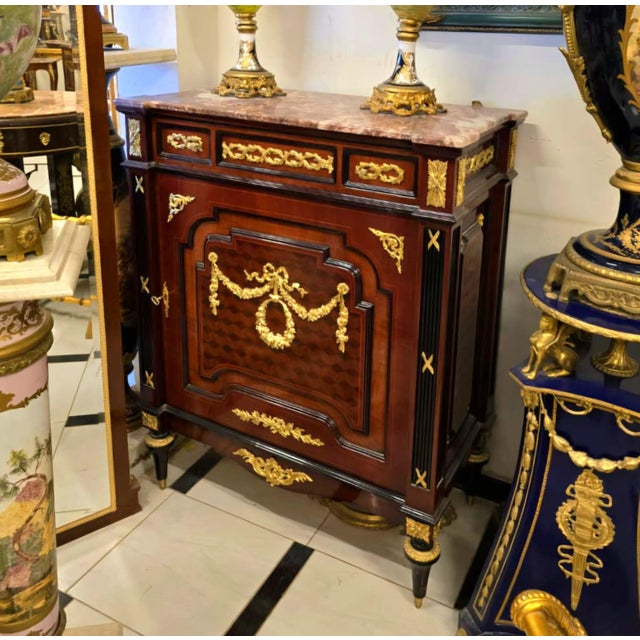 Bring timeless French sophistication into your home with this elegant French Louis XVI Accent Cabinet, masterfully...