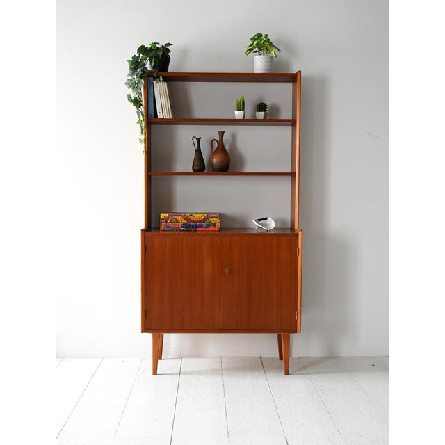 Vintage wooden bookcase with base with two hinged doors, internal shelf and upper part with open shelves. Original...