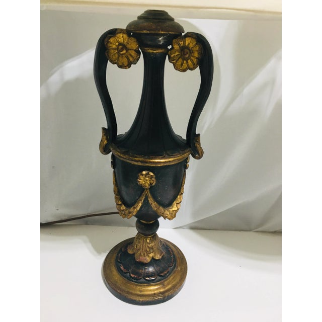 This pair of lamps are carved painted wood with applied gold leaf accents. The urns date from the 19th century and the...