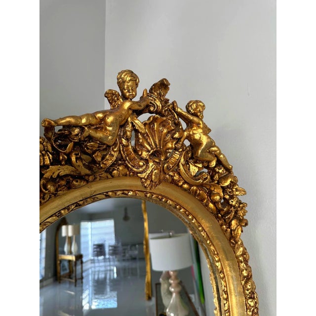 This stunning French-style full-length mirror features intricate gold leaf detailing and exceptional craftsmanship. Two...