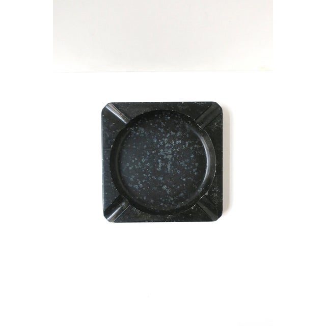 A substantial English black marble ashtray or catchall vide-poche, circa early to mid-20th century, England. Piece is...