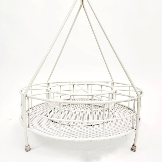 White painted iron bottle rack, Italian manufacture, dating back to the 1970s. The object features a circular structure,...