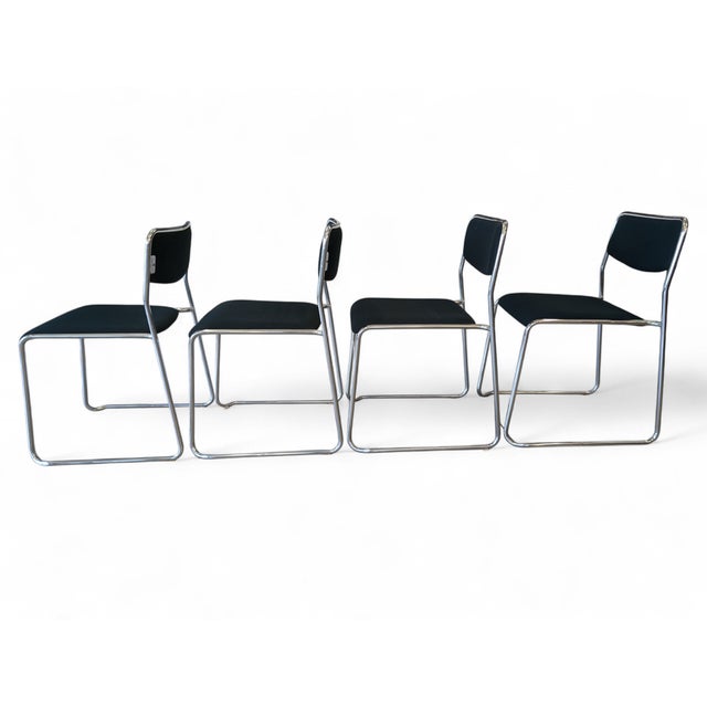 This refined set of four stackable chairs from the 1980s perfectly embodies the rationalist and functional design of the...
