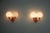 This pair of orange metal and opaline glass wall lamps was manufactured in germany in the 1960s. Each lamp features two...