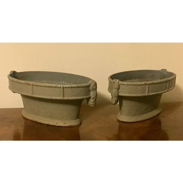 Pair French Art Deco cast iron oval basket form garden urns in gray paint. Each measures 14 3/4" across the front over...