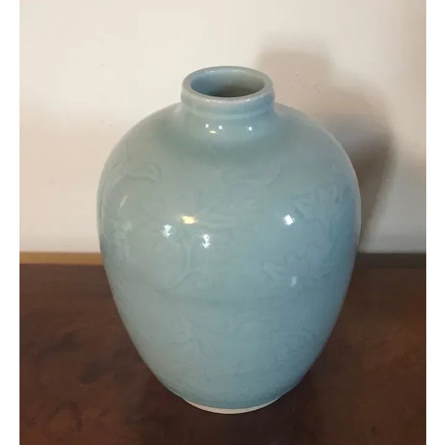 Antique 19th c. Chinese monochrome celadon glaze porcelain vase. Overall relief carving of vines and flowers. Heavily...