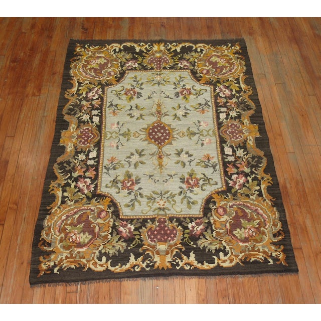A midcentury intermediate-size Besserabian Kilim with floral elements throughout. 5' x 7'6''