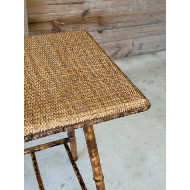 Charming antique bamboo side table or plant stand featuring a newly added woven rattan top with coordinating rattan trim....