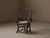 Folk Art armchair made from bent and assembled hazel branches, with a rounded backrest featuring circular and oval motifs...