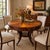 Striking vintage round table from the Ernest Hemingway Collection by Thomasville, featuring an elaborate radial pinwheel-...