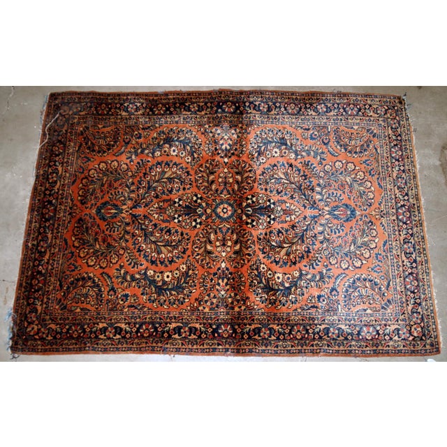 Handmade antique Persian Sarouk rug in original condition, it as some age wear on one corner. The rug is from the...