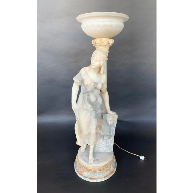 Sculptural torchère lamp of a woman, made of marble and alabaster. Italy, Late 19th Century. Dimensions: Height 40" x...
