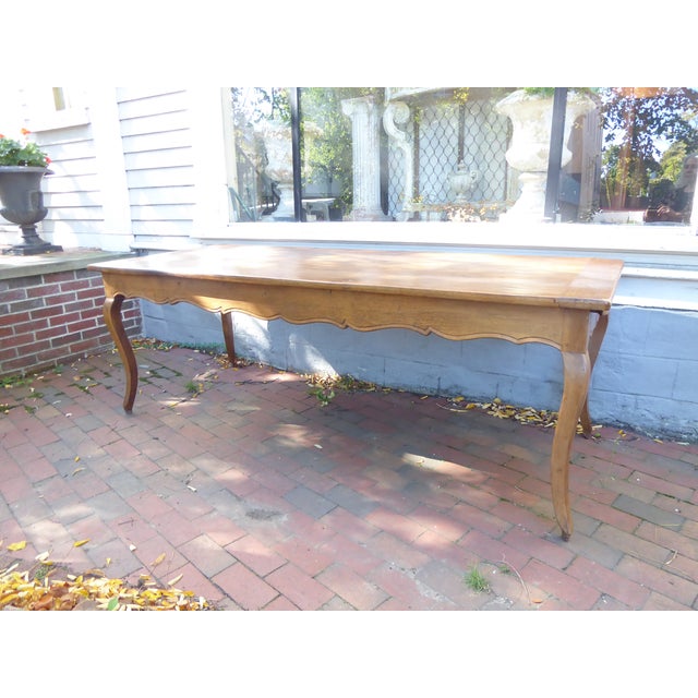 This French solid oak dining table has a breadboard in on end and a drawer in the other. The clearance for the legs is 24"...