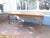 This French solid oak dining table has a breadboard in on end and a drawer in the other. The clearance for the legs is 24"...