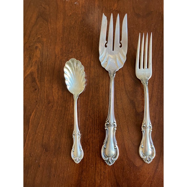 International Silver, Joan of Arc pattern of sterling set, with knife, fork and spoon place setting as well as large...