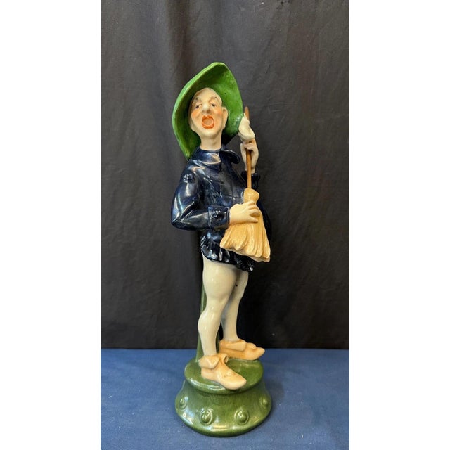 This vintage early 1900’s Continental statue of a troubadour is designed with a colorful costume. The subject is seen...