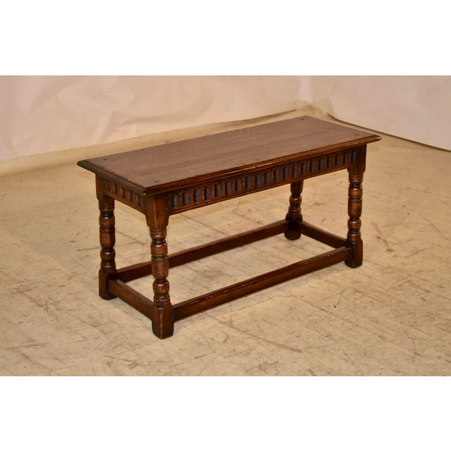 Late 19th century oak joint bench from England. The top is made from two boards and has a beveled edge and pegged...