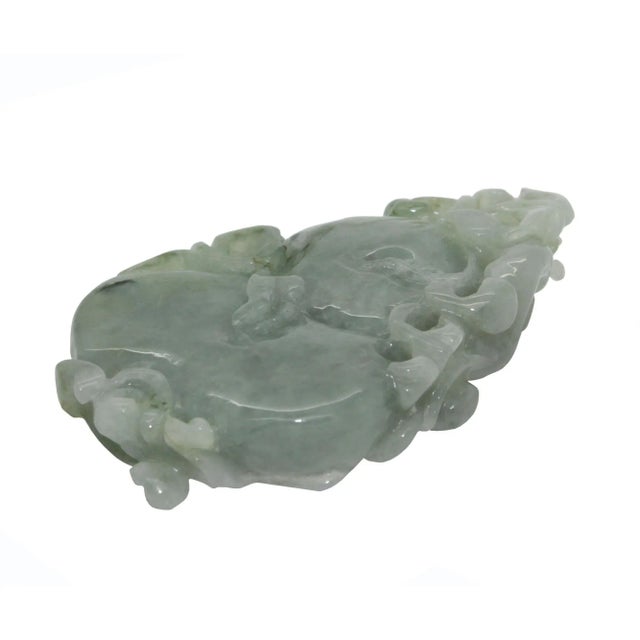 This beautiful pendant is carved from natural untreated jade, the motif of this pendant is a dragon on a gourd stepping on...