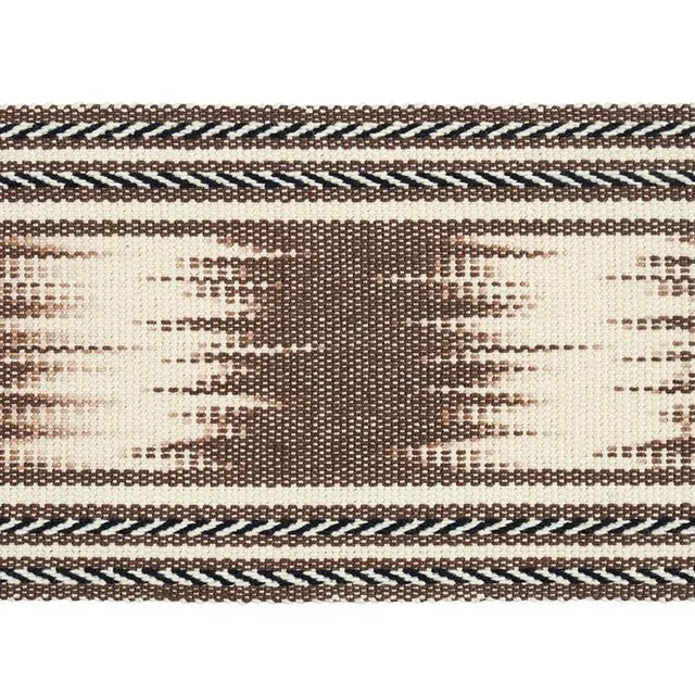 A warp-printed ikat woven by hand, this layered, pattern-on-pattern tape features a striped edging and incredible...