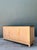 This vintage credenza combines warm-toned wood with a smooth stone top, a material pairing that reflects the clean,...