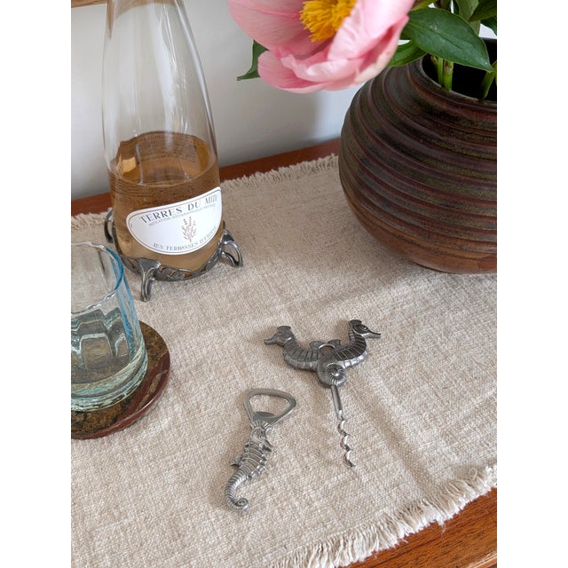 A rare set of two seahorse shaped Just Andersen pewter wine and crown bottle openers. Made in the 1930s and featuring the...