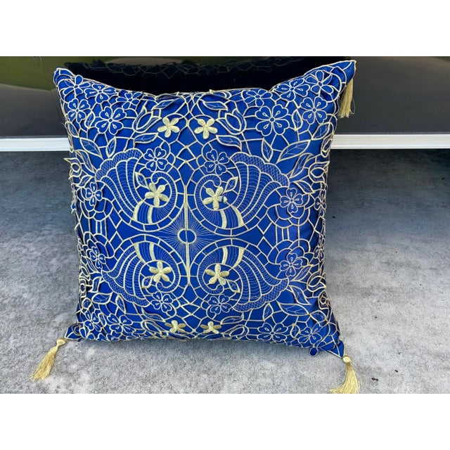 Large Pillow for a couch, chair or bed. Gold lace fabric overlapping deep blue shinny fabric There are also 4 gold tassels...